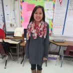 Megan Wu, a senior, is wearing a sweater dress from Target, scarf from Charlotte Russe, leggings from Athleta and Nine West boots. 