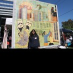 SNHS President Shivani Raman poses in front of a MECA mosaic mural at the Dia de Los Muertos Festival.