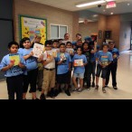 Claudia Heymach (10th from the left, in back) with Davila Elementary School students, dropping off children’s books.