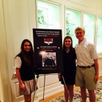 (From left) seniors Katya Gustafson, Emily Hallmark and Ross Ackerman smile for a picture next to the sign announcing Marcus Luttrell’s speech.