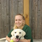 Natasha Schepps, who's holding Kylie, spends three days a week working at Rover Oaks Pet Resort as a Pet Care Technician, caring for and playing with pets lodging at the resort.