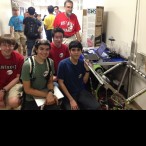 Robotics club members pose next to a machine they built that projects a ball up to 12 feet into the air. (From left) Matthew Dauber (sophomore), Henryk Viana (sophomore), Michael Murphey (junior), Andrew Advani (senior).