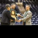 Head Cross Country Coach, Tony Brillon, accepts the state trophy from Athletic Director, Elliot Allen and Executive Director of Athletics, Paige Hershey. This is the second state trophy the cross country runners have been awarded. (Photo: Rebecca Williams