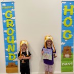 Charlie and Molly Hillman with Groundhog Day banners