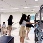 students place phones in phone cart