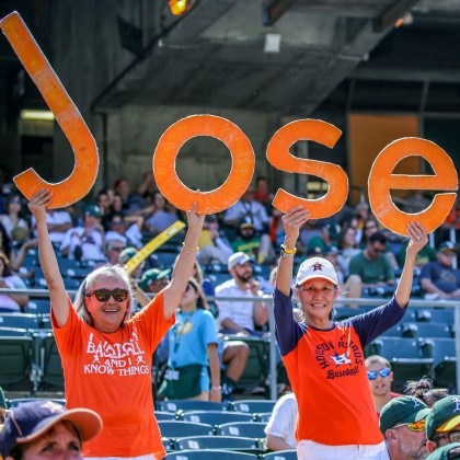 Barbara Moon (on right) and longtime friend Susanna Tom (on left), cheer for Jose Altuve.
