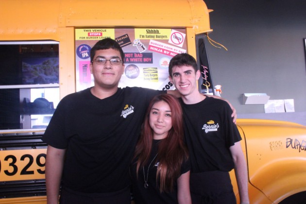 John Bonilla, Maria Bustes, and Alex Strong (from left) enjoy their job at Bernie’s Burger Bus, seating and serving customers.