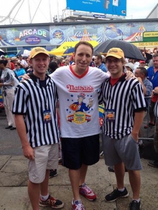 Zach Pearson (left) and his friend Andrew Hoffman (right) pose for a photo with champion competitive eater, Joey Chestnut (center). Both Zach and Andrew were judges at the Nathan’s hot dog eating contest this summer.