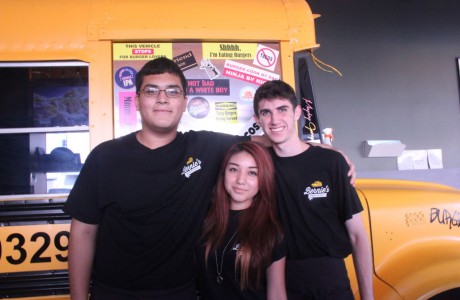 John Bonilla, Maria Bustes, and Alex Strong (from left) enjoy their job at Bernie’s Burger Bus, seating and serving customers.