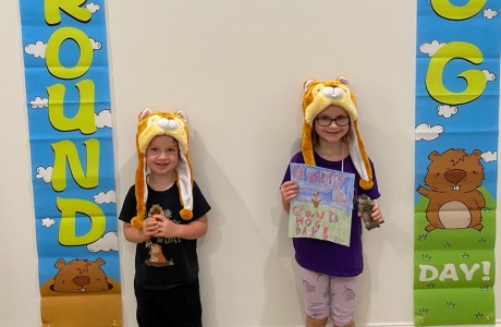 Charlie and Molly Hillman with Groundhog Day banners