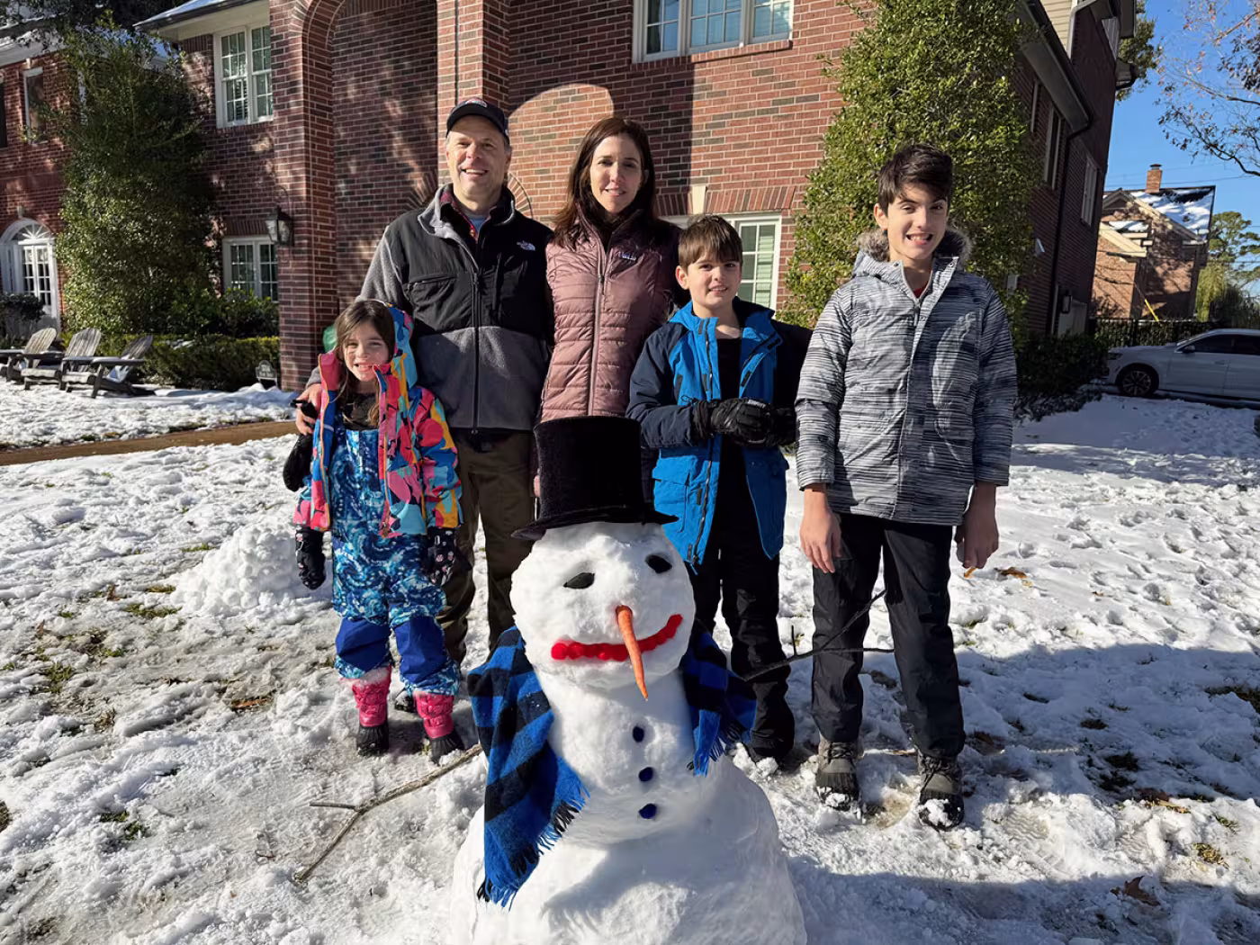 Juliana, Stephen, Kelley, Alex, and Ben Eubank with their snowman in West U. 