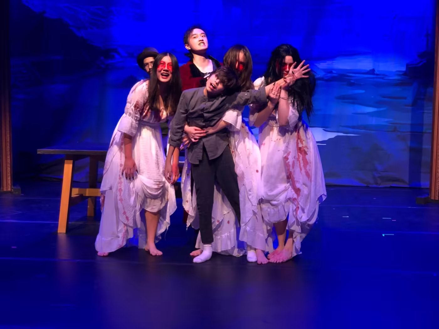 Brides and Dracula on stage