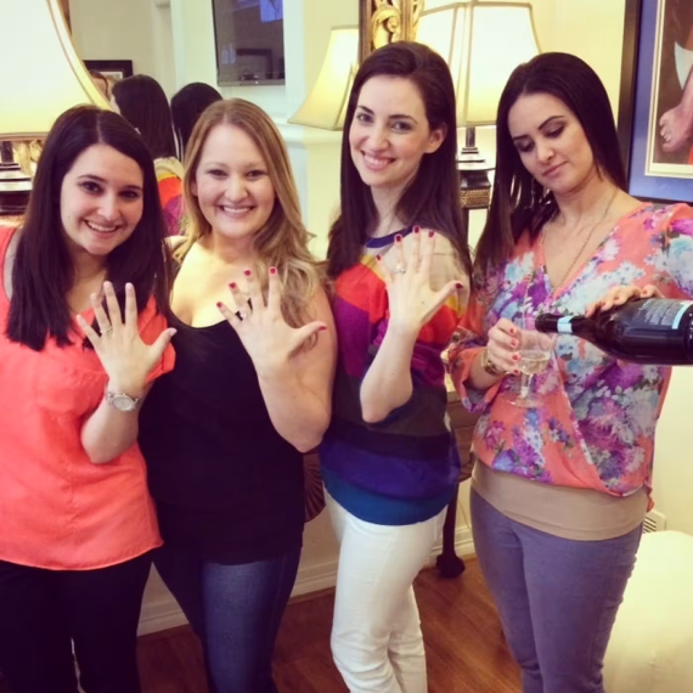 (From left) Sisters Melanie, Melissa and Amy displaying their rings and Lauren, on right, pouring the champagne to toast her younger sister’s engagement. (Photo: Mark Finkelstein)