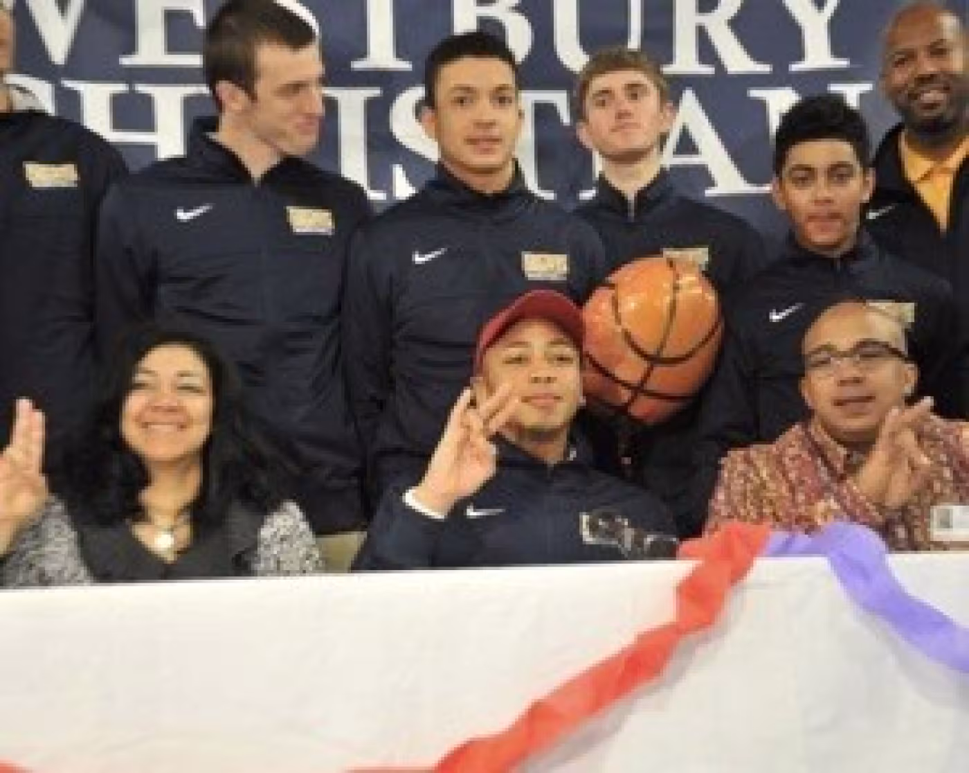 Galen Robinson (bottom center) with his parents, varsity basketball coach Trey Austin (top right) and basketball teammates (from left) Grant Hazel, Tucker Toole, Travis Hicks, Kase Carrera.