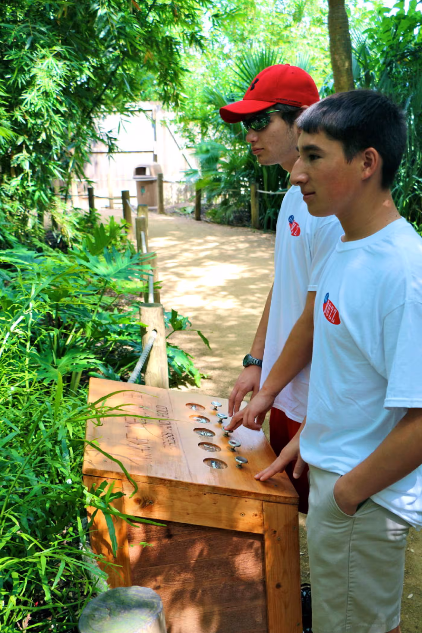 Mark and Jacob try out the controls in the Extreme Bugs exhibit.