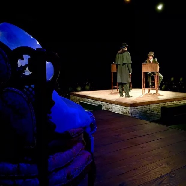  On the stage standing is Adam Kobs and sitting is Remy Garfield. The white figure sitting in the chair is Rebecca Glenister who played the ghost of Christmas past.