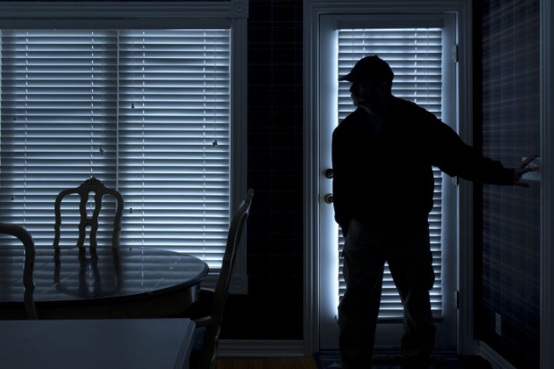 Burglar breaking in at night