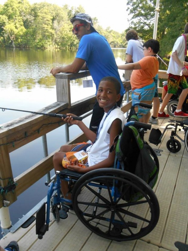 Camper B.J. Bond fishing with his counselor. (Photo provided by MDA Houston Goodwill Ambassadors)