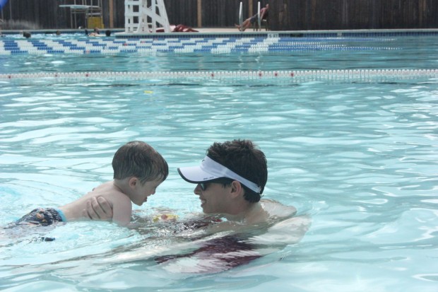 Cole Holan (right) gives swim lessons at the Evergreen Pool each morning to many new and eager swimmers, including Charlie Clifton (left).