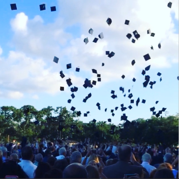 Pictured are the students of the Class of 2014 celebrating their graduation with the tradition of throwing their caps in the air. (Photo: Madi McIntyre) 