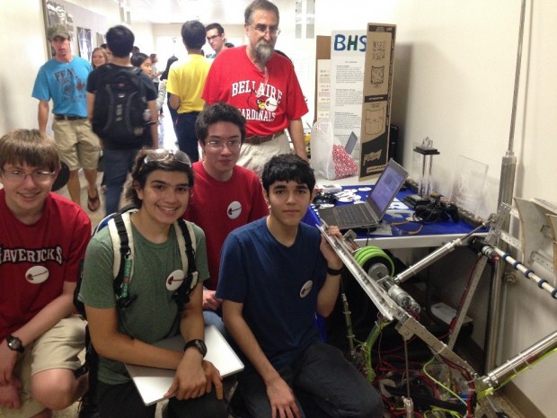 Robotics club members pose next to a machine they built that projects a ball up to 12 feet into the air. (From left) Matthew Dauber (sophomore), Henryk Viana (sophomore), Michael Murphey (junior), Andrew Advani (senior).