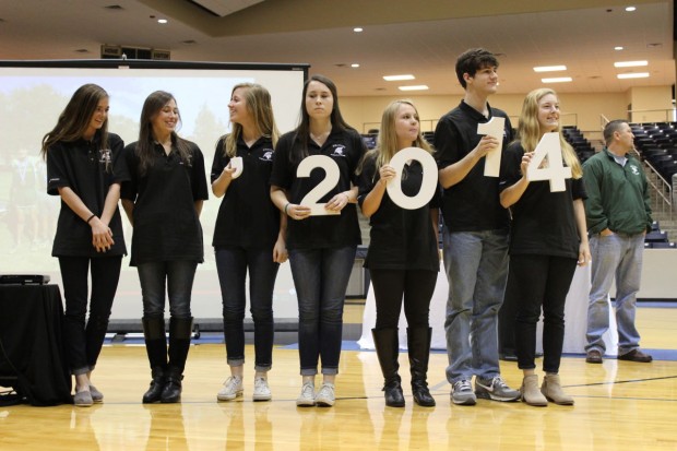  Seniors Charlotte Kaiser, Morgan Brast, Christi Gregory, Hanna Lauritzen, Grace Whitmire, Tucker May, and Harper Jones, members of the Student Council executive board, presented the Cross Country team with the 2014 numbers that will be placed outside of 