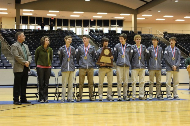 The Stratford Cross Country team members Sam Evett, Devin Fahey, Jake Roberts, Douglas Baker, Paul Bradstrom, and Austin and Hayden Richards, accept the state championship trophy during the ceremony at Don Coleman Coliseum. 