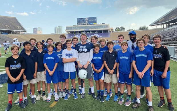 Students on the field with Adam