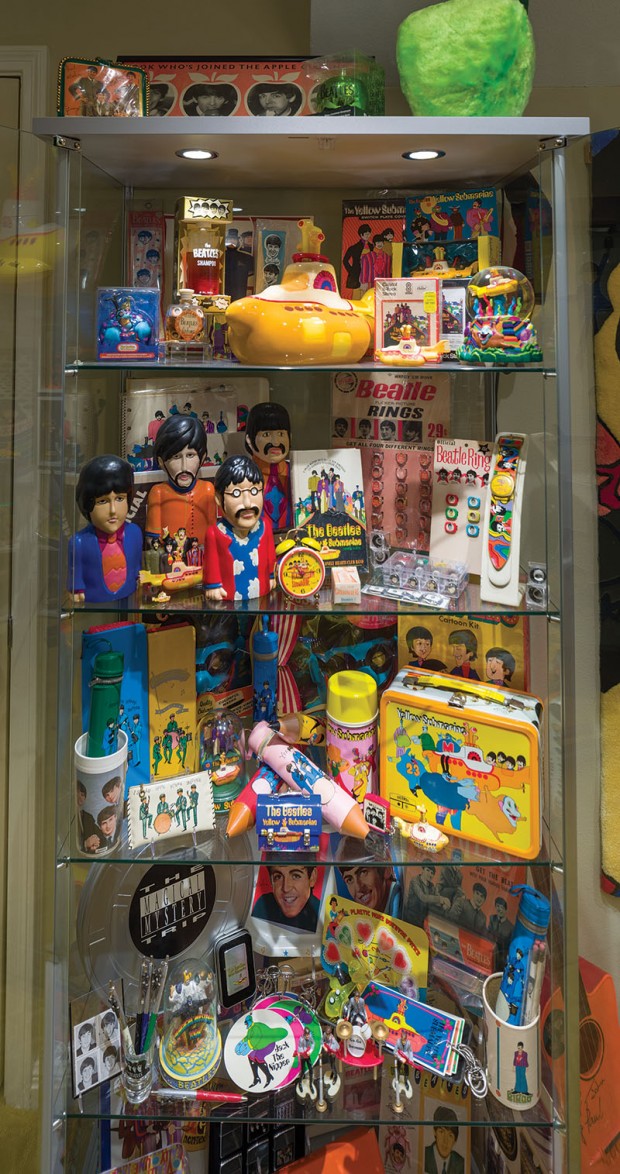 Period Beatles toys and baubles line the shelves.