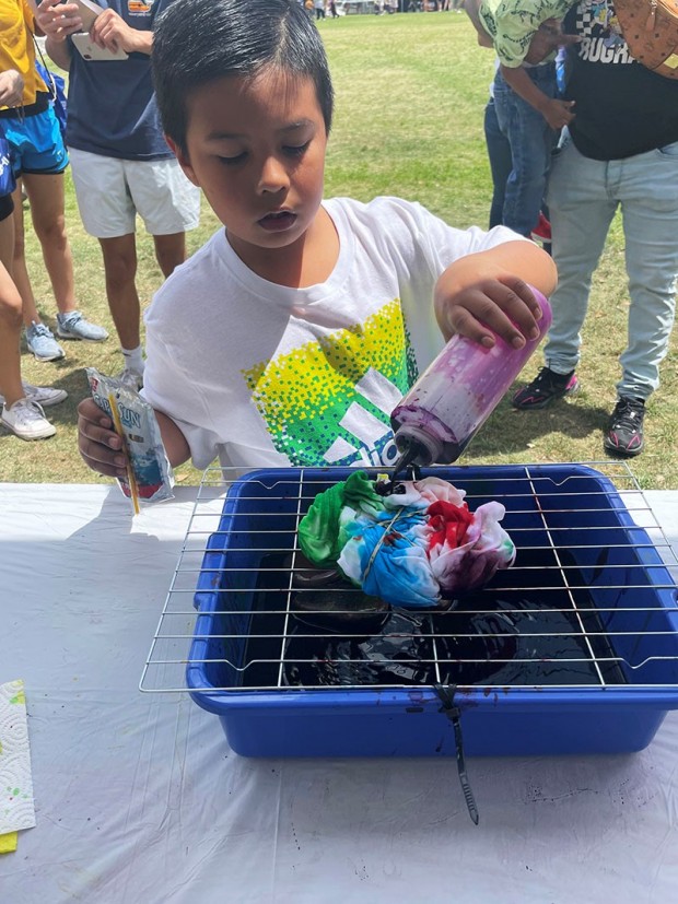 Kid at tie dye booth