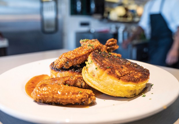 Fluffy hoe cornmeal cakes served with fried wings and maple chipotle glaze