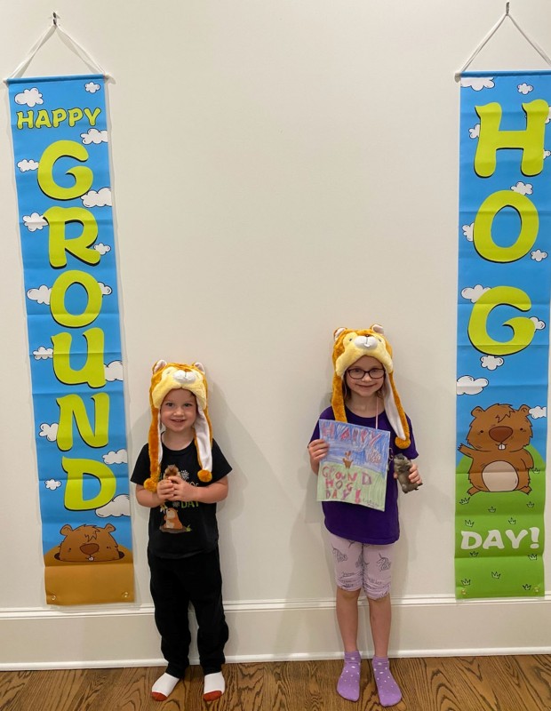 Charlie and Molly Hillman with Groundhog Day banners