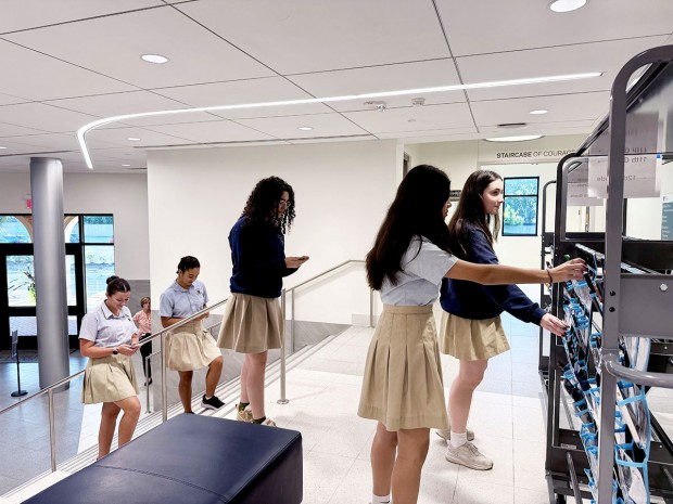 students place phones in phone cart