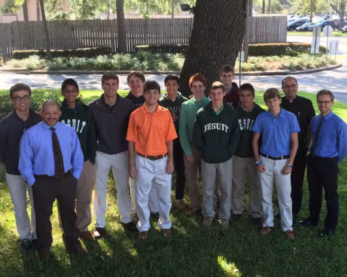 (From left) Brandon Bain, theology teacher Mr. Tommy Romano, Martin Montalvo, Nick Tanner, Felix Read, Patrick Sullivan, Toan Cao, Austin Miller, Jeremy Brown, Michael Blaschke, Thomas Neiers, Brandon Solcher, Fr. Flavio Bravo, Jesuit Father, Head of Past